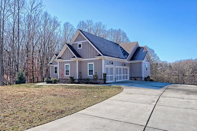 craftsman inspired home with a garage and a front lawn