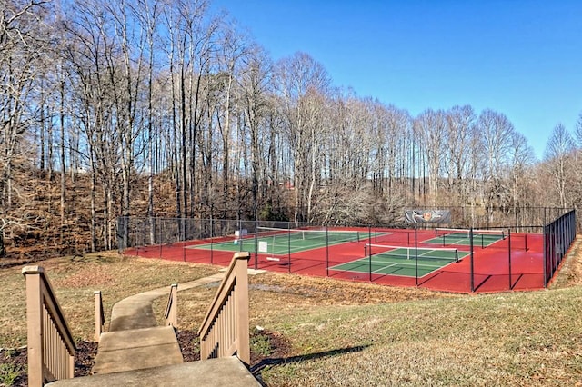 view of sport court with a lawn