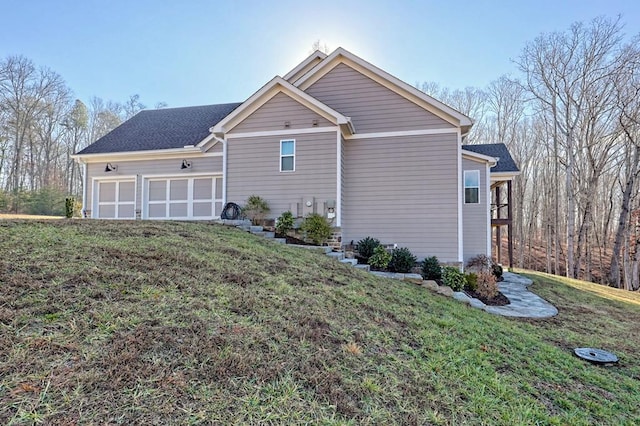 view of property exterior with a garage and a lawn