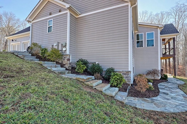 view of property exterior with a garage and a yard