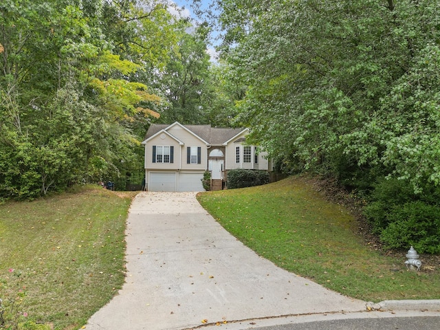 view of front of property with a front yard and a garage