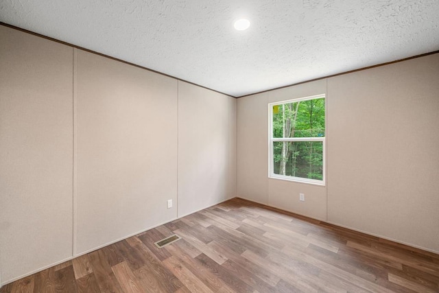220 Jetty Dr, Ellijay, GA 30540 - empty room featuring wood finished floors, a textured ceiling, recessed lighting, and ornamental molding