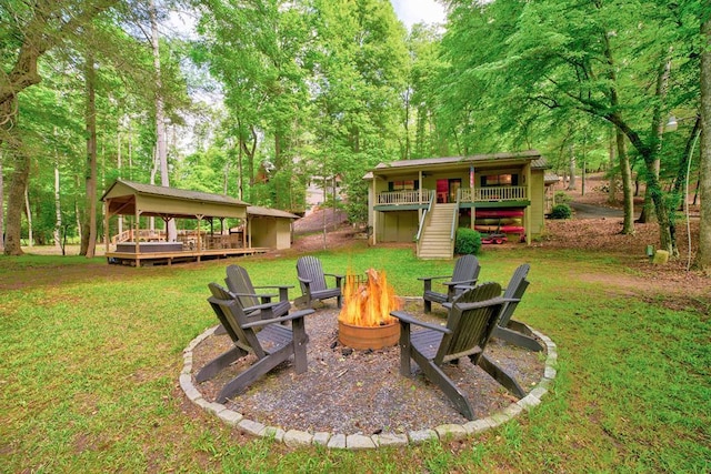 view of yard with a deck and a fire pit