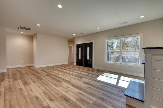 unfurnished living room with light wood-style flooring, visible vents, and recessed lighting