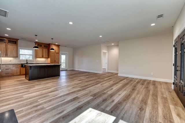 unfurnished living room featuring light wood-style floors, baseboards, visible vents, and recessed lighting