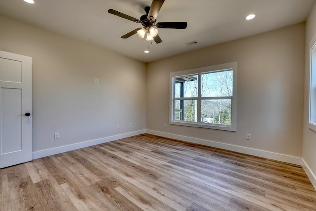 spare room featuring light wood finished floors, visible vents, baseboards, a ceiling fan, and recessed lighting