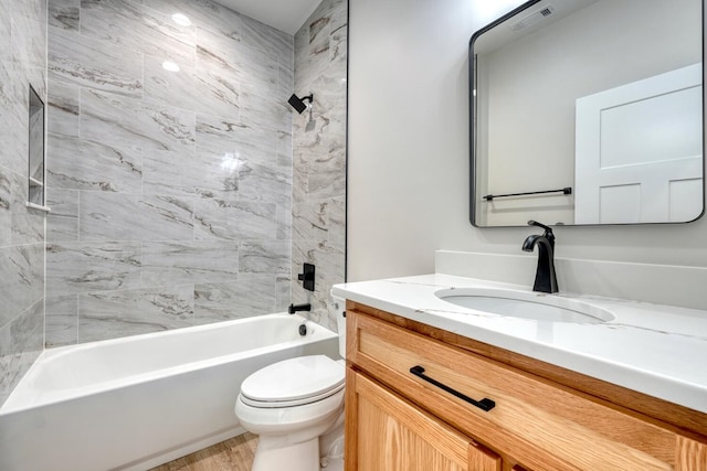 bathroom with visible vents, vanity, toilet, and shower / bathtub combination