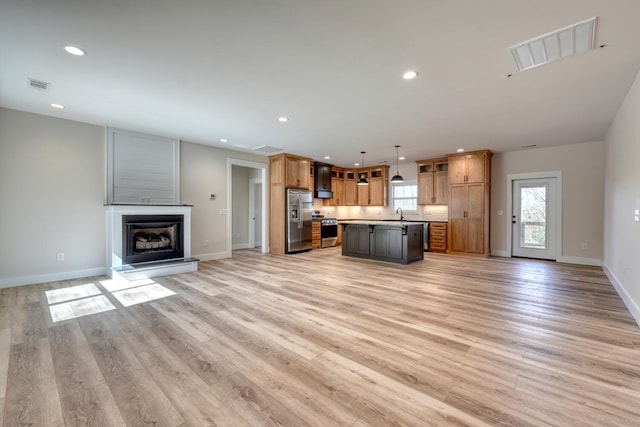 unfurnished living room with light wood-style flooring, visible vents, and recessed lighting