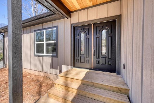 view of exterior entry with board and batten siding