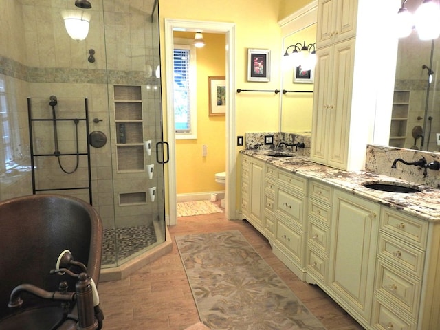 120 Sunrock Mountain Trc, Blue Ridge, GA 30513 - full bath with double vanity, a stall shower, a freestanding bath, wood finished floors, and toilet
