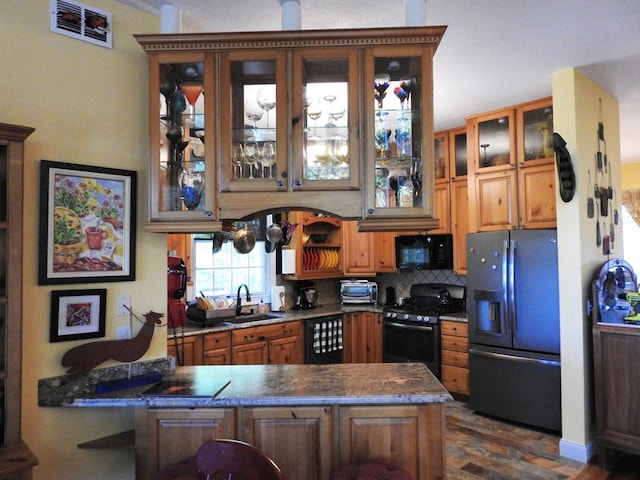 120 Sunrock Mountain Trc, Blue Ridge, GA 30513 - kitchen featuring black appliances, a peninsula, a sink, glass insert cabinets, and tasteful backsplash