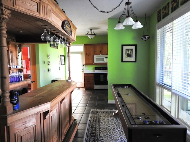 120 Sunrock Mountain Trc, Blue Ridge, GA 30513 - kitchen with stove, white microwave, dark tile patterned flooring, butcher block countertops, and decorative light fixtures
