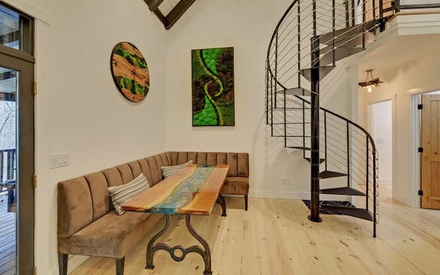 7670 Hiawassee Wilderness, Hiawassee, GA 30546 - staircase featuring wood finished floors, high vaulted ceiling, baseboards, and beam ceiling