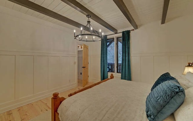 bedroom with a notable chandelier, light hardwood / wood-style floors, and beam ceiling