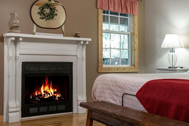 608 Pine Pass Cir, Mineral Bluff, GA 30559 - living area with a lit fireplace and wood finished floors