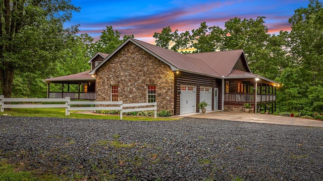 608 Pine Pass Cir, Mineral Bluff, GA 30559 - view of front of house featuring stone siding, a garage, a porch, driveway, and metal roof