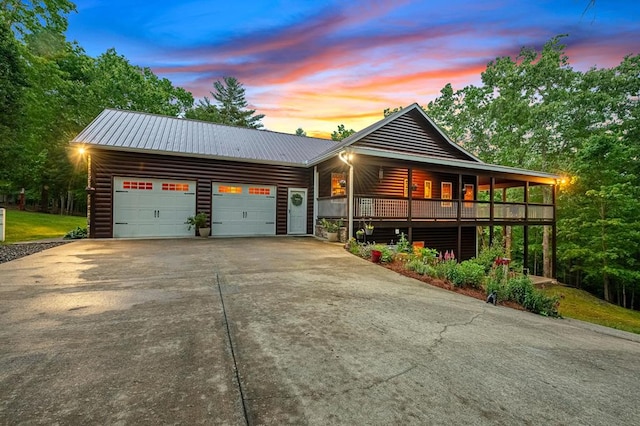 608 Pine Pass Cir, Mineral Bluff, GA 30559 - view of front of house featuring faux log siding, concrete driveway, an attached garage, and metal roof
