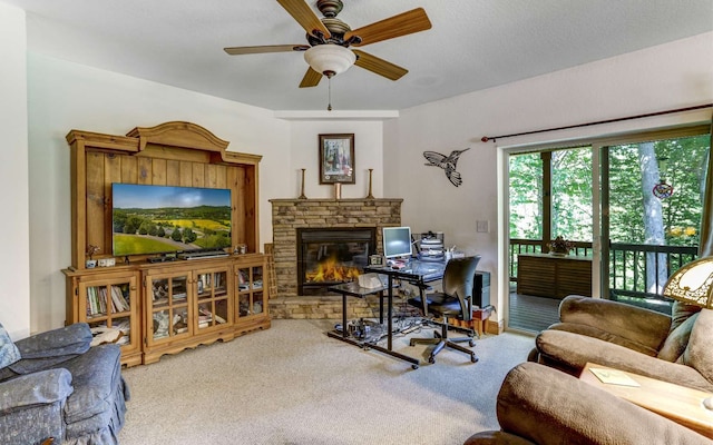 living room featuring ceiling fan, light carpet, and a fireplace