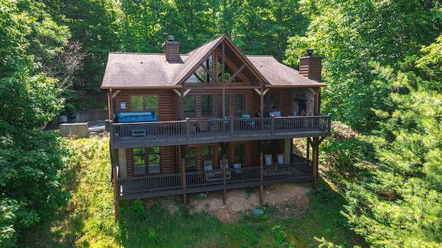 437 Spruce Cir, Mineral Bluff, GA 30559 - back of house featuring a chimney, a view of trees, and a deck