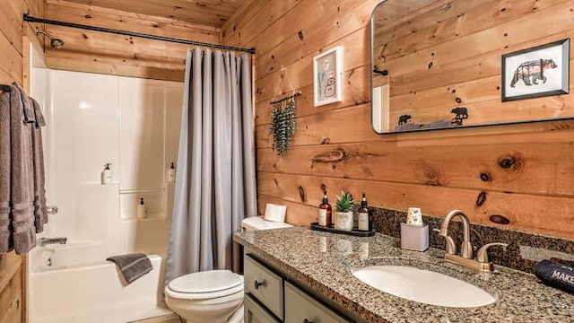 437 Spruce Cir, Mineral Bluff, GA 30559 - bathroom featuring wood walls, vanity, toilet, and shower / bath combo with shower curtain
