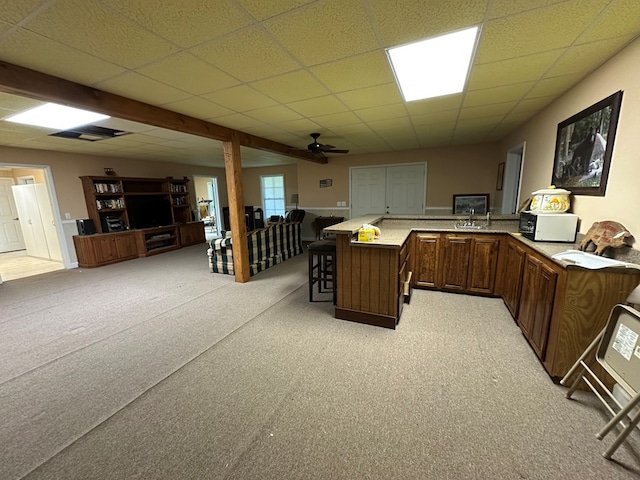 1207 Bullen Gap Rd, Blue Ridge, GA 30513 - kitchen with open floor plan, a breakfast bar area, light carpet, a ceiling fan, and a drop ceiling
