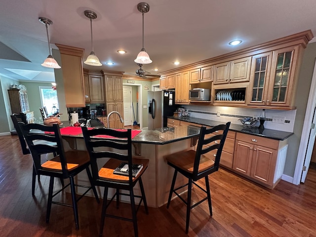 1207 Bullen Gap Rd, Blue Ridge, GA 30513 - kitchen featuring appliances with stainless steel finishes, a peninsula, backsplash, a kitchen breakfast bar, and dark wood-style floors
