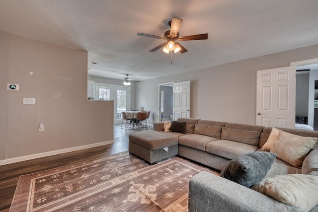 living room featuring ceiling fan, wood finished floors, and baseboards