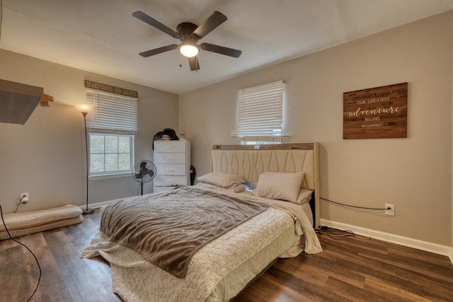 bedroom with ceiling fan, dark wood-type flooring, and baseboards