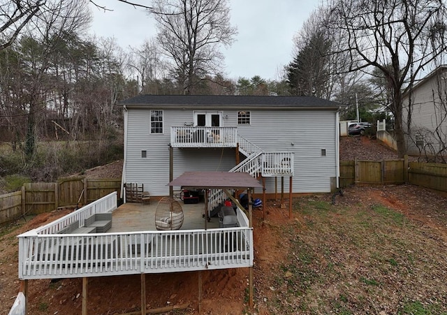 back of house with a fenced backyard, a gate, stairway, and a wooden deck