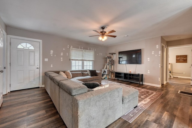 living room with baseboards, visible vents, ceiling fan, and dark wood-type flooring