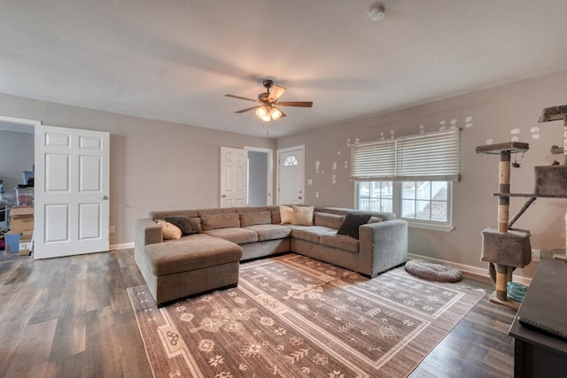 living room with wood finished floors, a ceiling fan, and baseboards