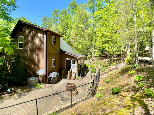 rear view of house with a patio and fence