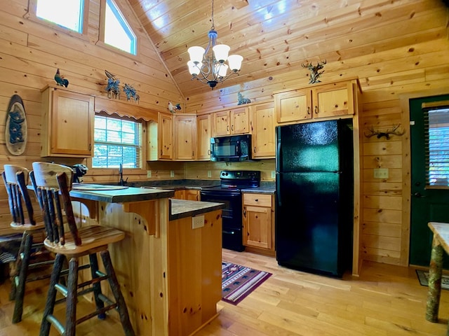 kitchen with dark countertops, wooden ceiling, black appliances, and a wealth of natural light
