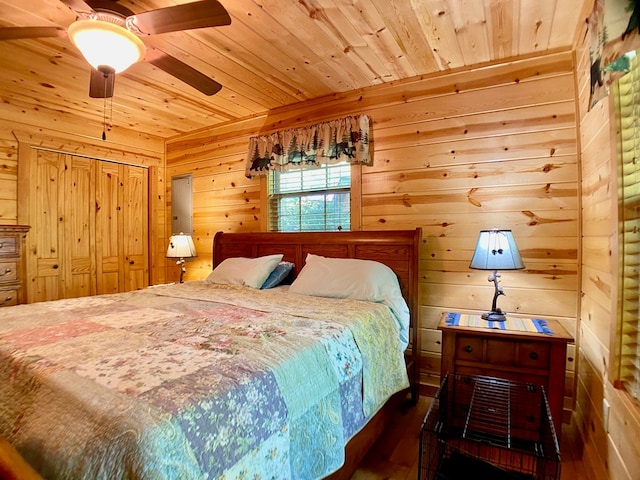 bedroom with wood ceiling, ceiling fan, wood finished floors, and wooden walls
