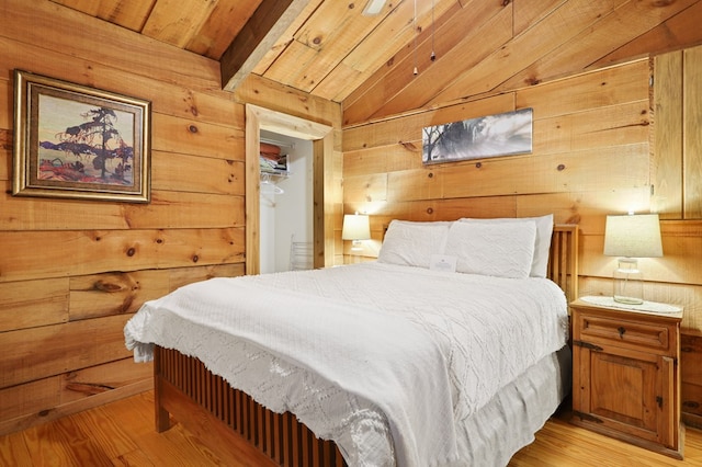 bedroom with light hardwood / wood-style flooring, vaulted ceiling with beams, and wooden ceiling