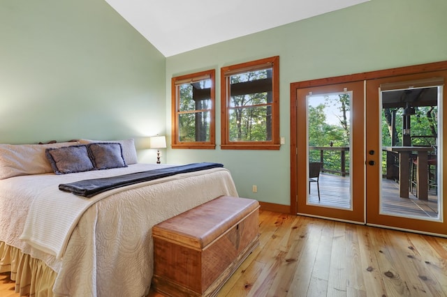 bedroom with light wood-type flooring, french doors, access to exterior, and lofted ceiling