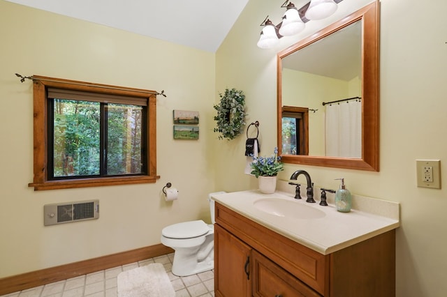 bathroom with tile patterned flooring, vanity, and toilet