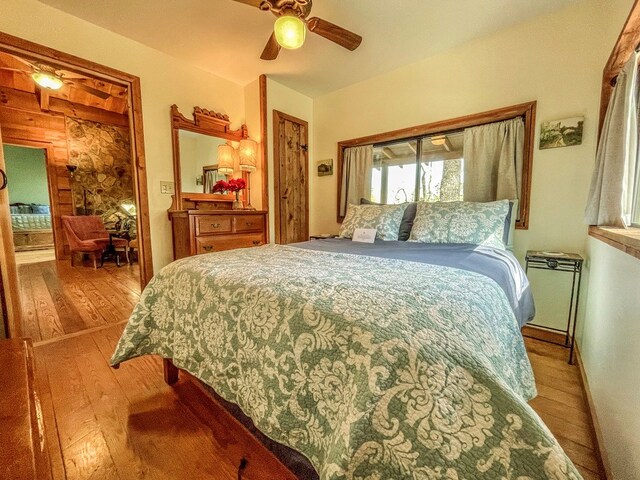 bedroom featuring ceiling fan, a closet, and wood-type flooring