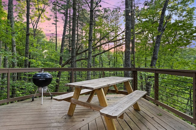 deck at dusk featuring area for grilling