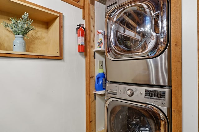 washroom with stacked washing maching and dryer