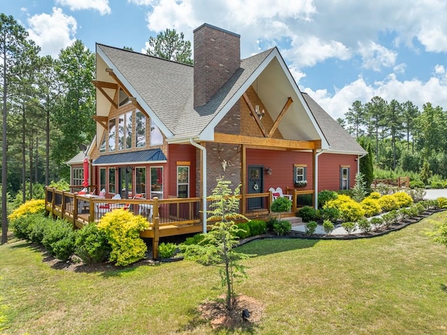 back of house featuring a yard and a wooden deck