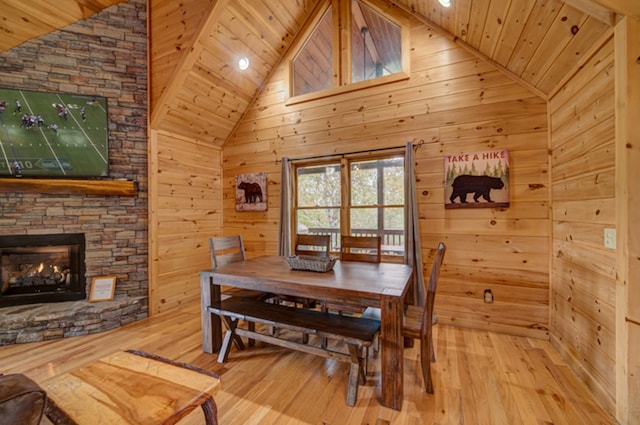 dining area with wood ceiling, wooden walls, and hardwood / wood-style flooring