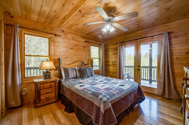 bedroom with french doors, light hardwood / wood-style floors, access to exterior, ceiling fan, and wooden ceiling