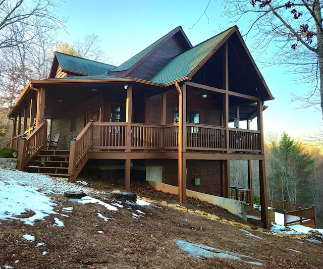 snow covered property with a porch