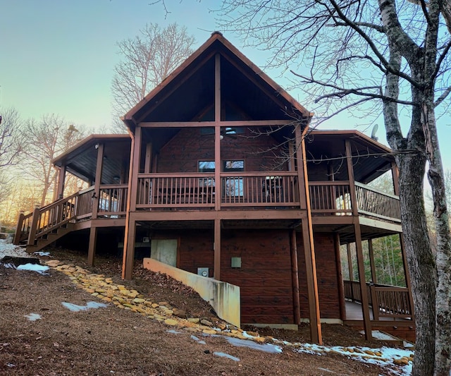 back of property featuring a wooden deck