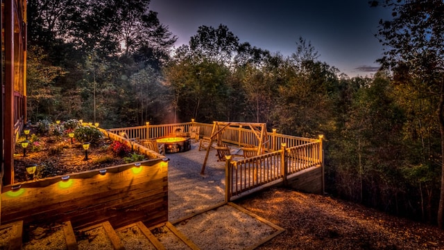 deck at dusk with a fire pit