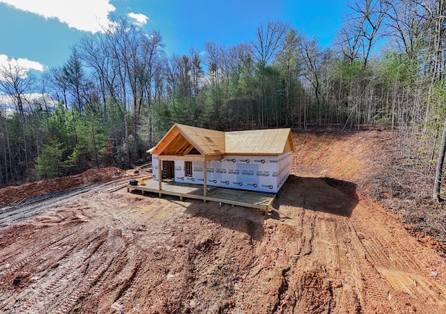 view of side of property featuring a wooden deck