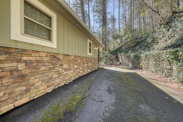 view of property exterior with stone siding