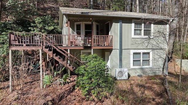 rear view of property with stairs