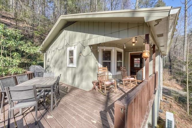 wooden deck with outdoor dining space